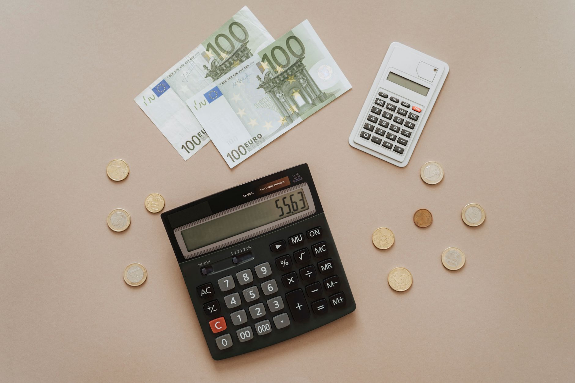 Flat lay of calculators and Euro currency, depicting financial calculations and budget management.